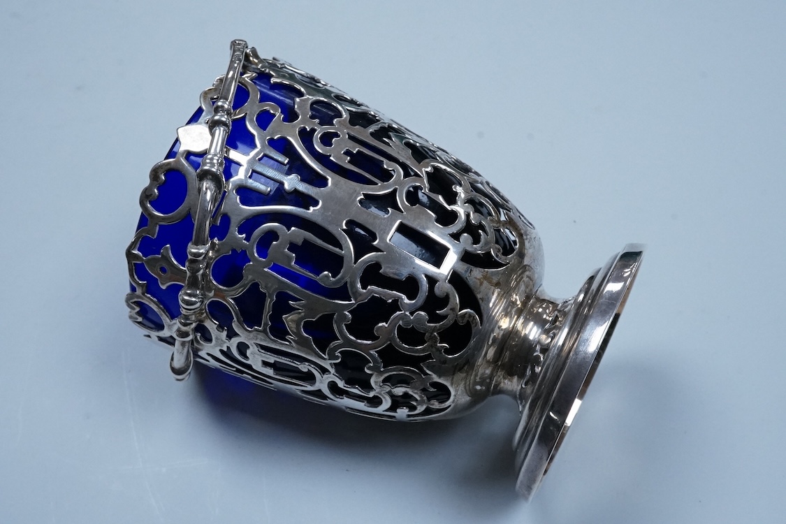A Victorian pierced silver sugar basket with blue glass liner, makers mark rubbed, London, 1851, height excluding handle, 13.2cm, 7.9oz.